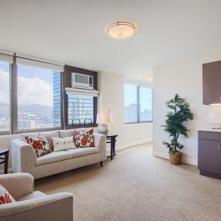 A modern apartment living room with a city view and cozy furnishings.