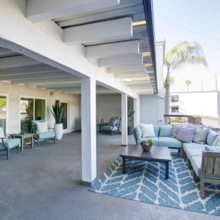 A modern outdoor patio featuring comfortable seating and stylish decor.