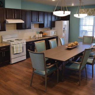 A modern kitchen and dining area with ample seating and contemporary appliances.