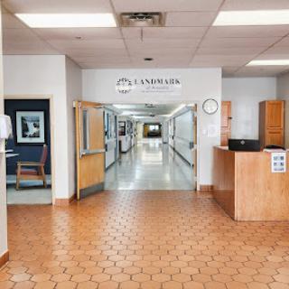 A view of the interior of a hospital, showcasing the reception area and a long corridor leading to patient rooms.