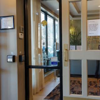 View of a welcoming reception area through a glass door.