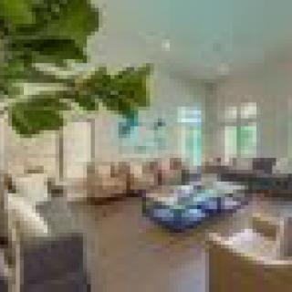 A modern and bright living room with stylish furniture and large windows.