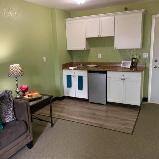 A cozy apartment with a small kitchenette and a comfortable living area.