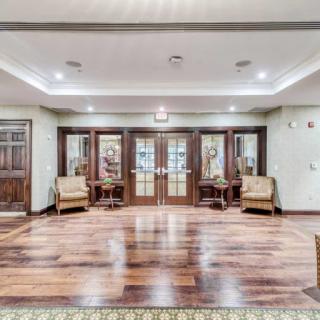 Spacious lobby with elegant wood flooring and comfortable seating.