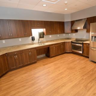 A modern kitchen with wooden cabinets and stainless steel appliances.