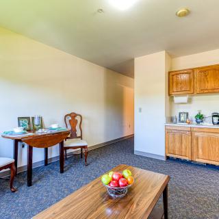 A cozy living space with a kitchenette and dining area.
