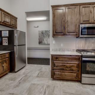 A modern kitchen featuring wooden cabinets and stainless steel appliances.