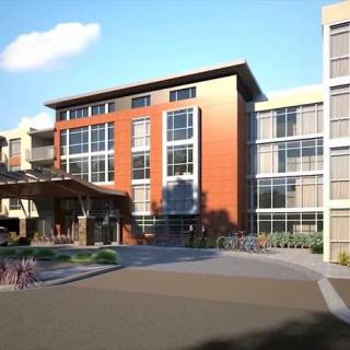 A modern apartment complex featuring a mix of materials and large windows.