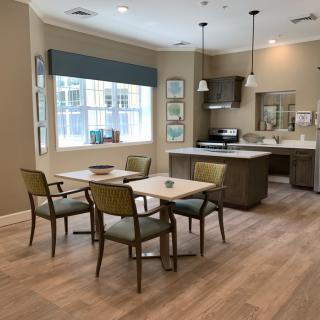A modern kitchen and dining area with wooden flooring and stylish furniture.