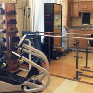 A room equipped with rehabilitation and exercise equipment for physical therapy.