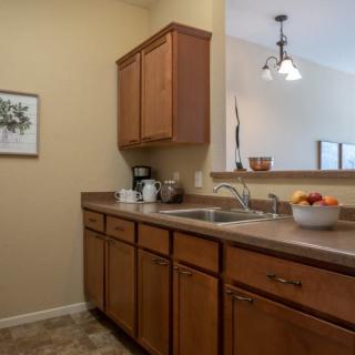 A cozy kitchen with wooden cabinets and modern appliances.