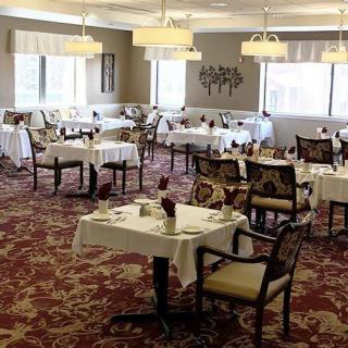 An elegant dining room with neatly arranged tables and chairs.
