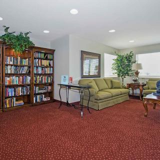 A cozy living room with a well-stocked bookshelf and comfortable seating.
