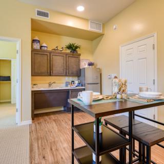 A cozy kitchen and dining area with wooden cabinets and a small dining table.