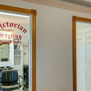 Interior of a vintage-style barbershop with a barber chair and mirror.