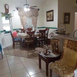 A cozy dining room with a table set and elegant decor.
