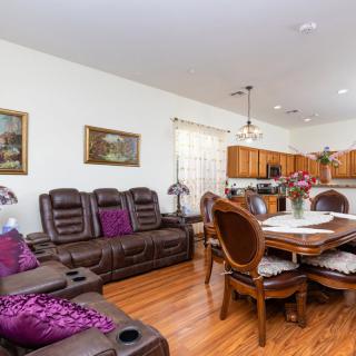 A spacious open-concept living and dining area with wood flooring and comfortable furnishings.