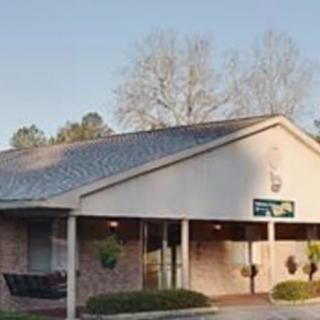 A small commercial building with a sloped roof on a clear day.