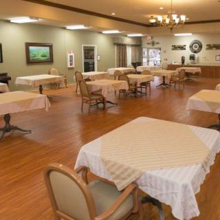 An empty dining area with neatly arranged tables and chairs.