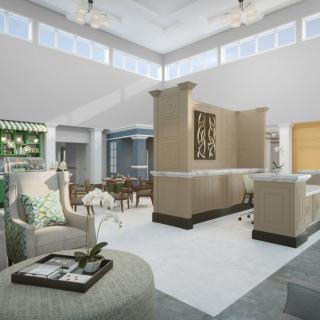 A spacious and modern living room with elegant furnishings and ample natural light.