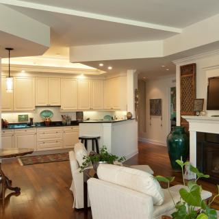 A modern open-concept living room and kitchen with stylish decor and a cozy seating area.
