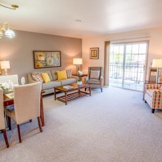 A cozy living and dining area with modern furnishings and a bright, inviting atmosphere.
