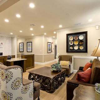 A cozy waiting room with comfortable seating and elegant decor.