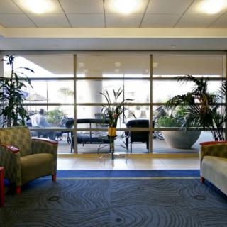 A modern lobby area featuring comfortable seating and large windows letting in natural light.