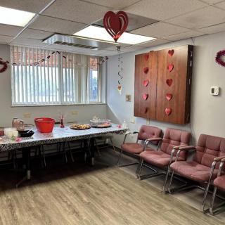 A decorated waiting room with heart-themed decor and seating area.