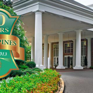 Front entrance of a hotel celebrating its 80th anniversary.