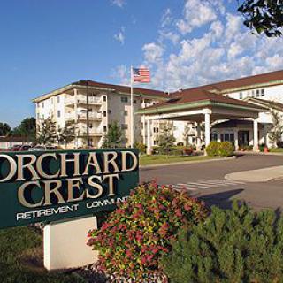 Orchard Crest Retirement Community entrance on a sunny day.