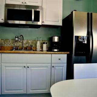 A modern kitchen featuring essential appliances and a clean design.
