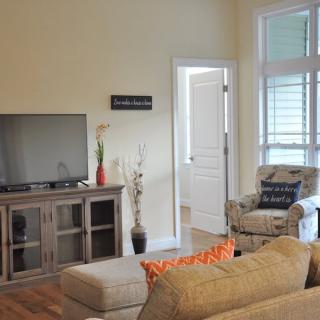 A cozy living room with a television and comfortable seating.