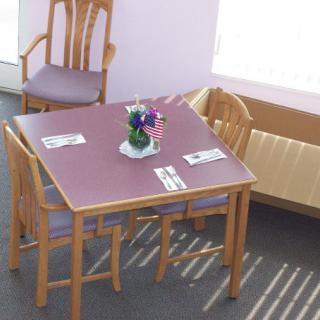 A cozy dining setup with a table, chairs, and floral centerpiece.