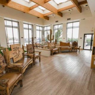Spacious lobby with natural lighting and wooden furnishings.