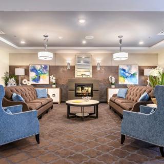 A cozy living room with elegant furnishings and a warm fireplace.