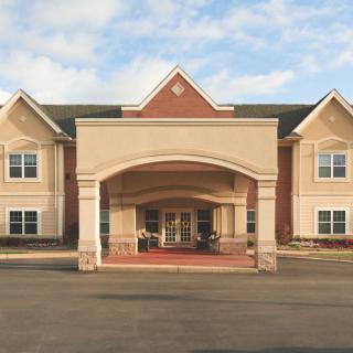 A symmetrical building with a prominent entrance, possibly a hotel or residential facility.