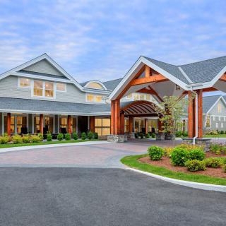 A modern building with a welcoming entrance and landscaped surroundings.