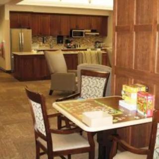 A cozy kitchen and dining area with a puzzle on the table.