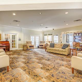 Spacious living area with comfortable seating and a piano.