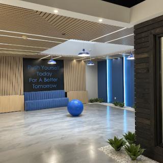 A modern and inviting workspace lobby featuring a blue seating area and decorative plants.