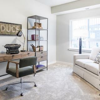 A stylish and modern home office featuring a sleek desk, comfortable seating, and ample natural light.