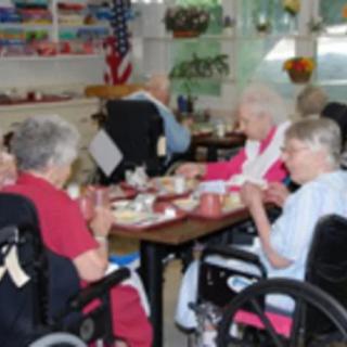 Elderly individuals dining together in a nursing home setting.
