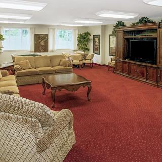 A spacious living room with comfortable seating and a large television.