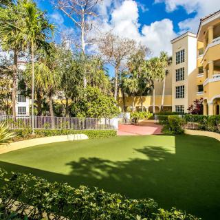 A well-maintained garden area in an apartment complex surrounded by lush greenery.