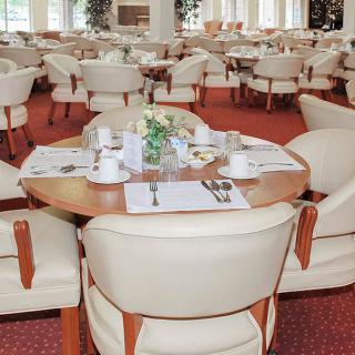 An elegant restaurant dining area with neatly arranged tables and chairs.