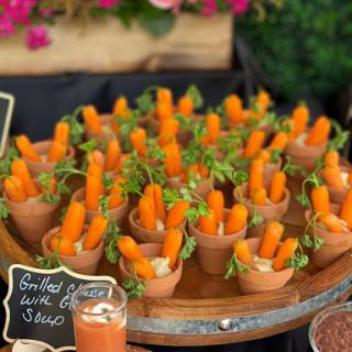 A delightful arrangement of carrot sticks presented in small cups, perfect for a fresh and crunchy snack.