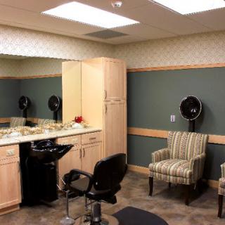 A modern hair salon interior featuring styling chairs, mirrors, and a cozy waiting area.