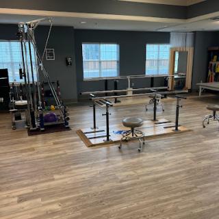 A well-equipped physical therapy room featuring various exercise equipment for rehabilitation.