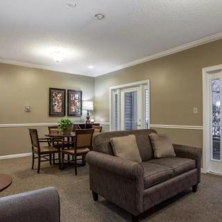 A cozy living room with a sofa, table set, and soft lighting.